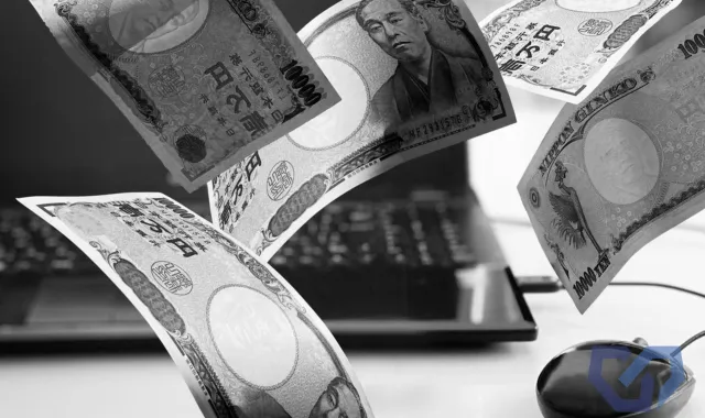 PCの前でお札が舞っている